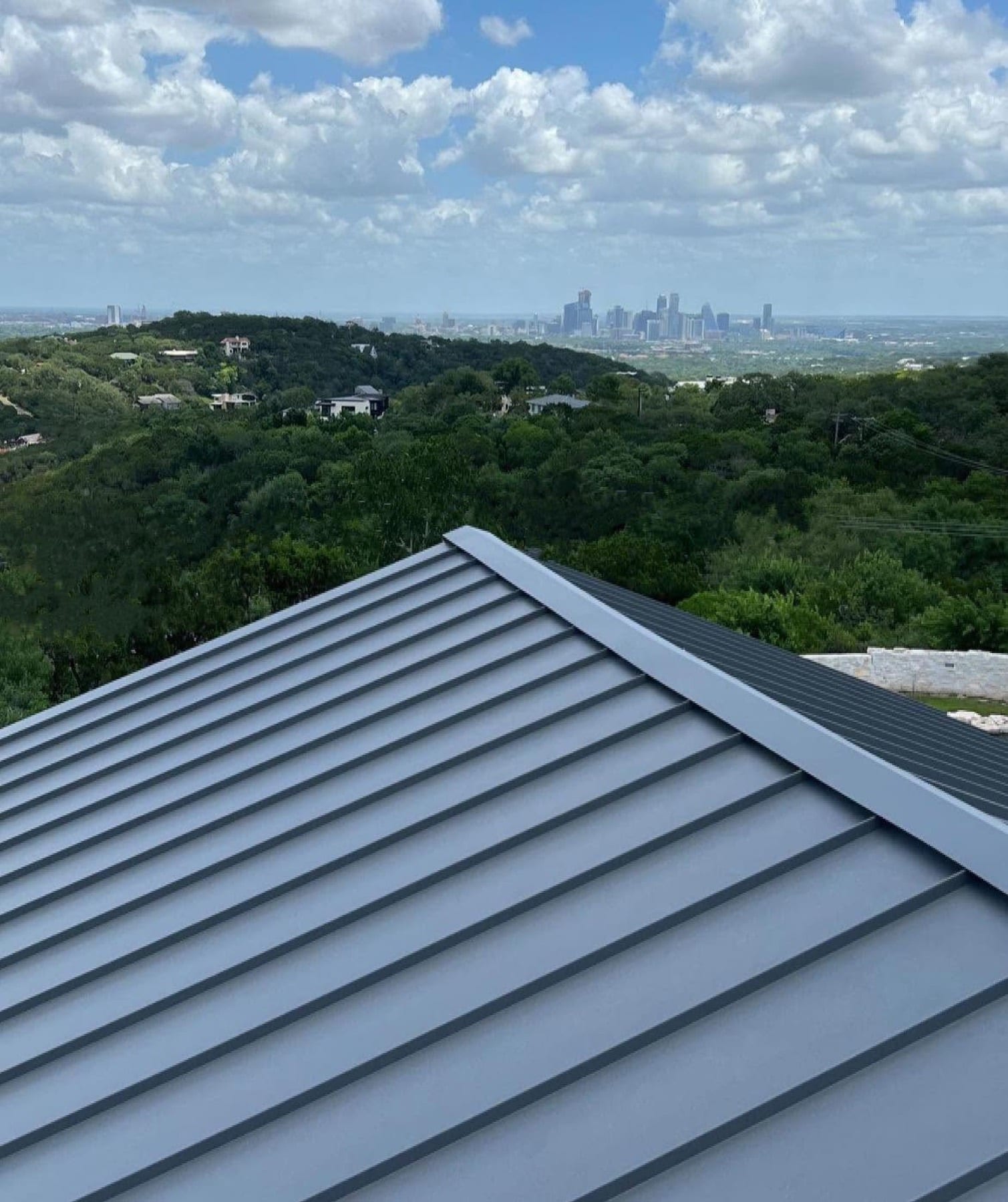 Standing seam metal roof with the Austin skyline beyond