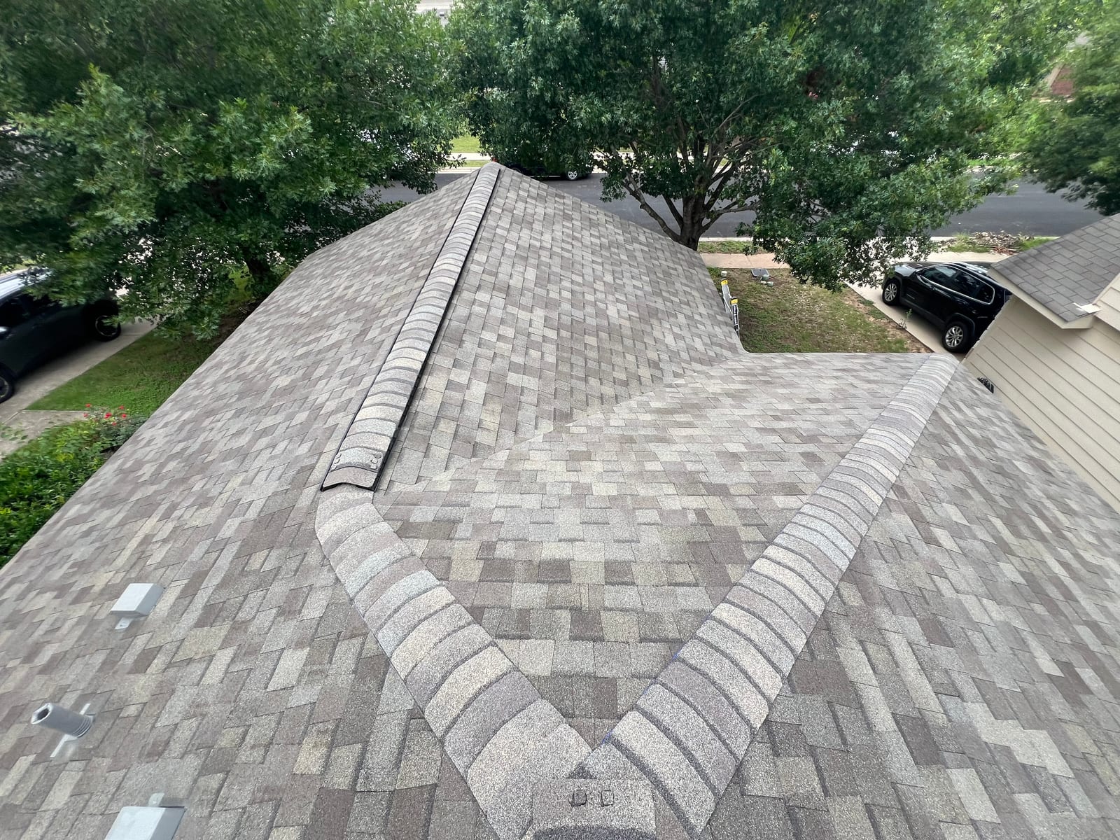 Front elevation of the new roof, hip and valley lines converging above the street
