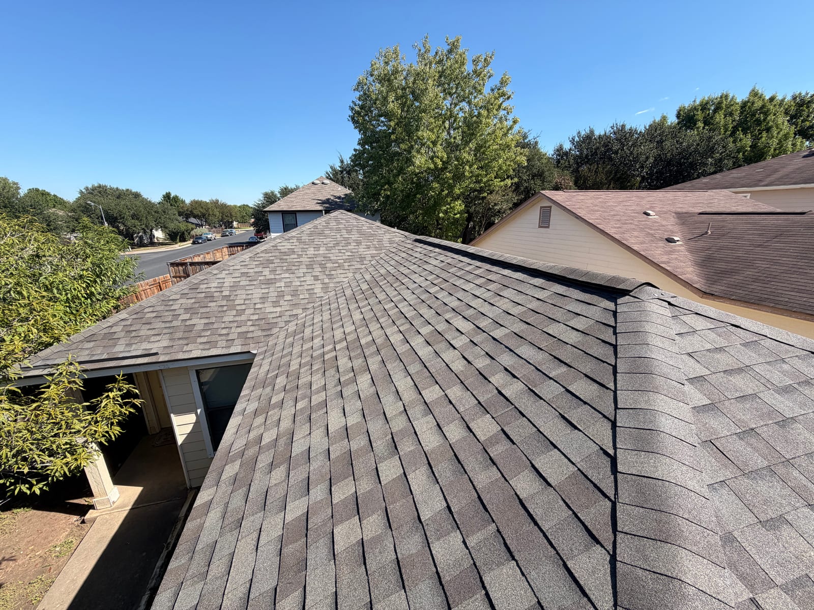 Finished Weatherwood architectural shingle roof on a single-story home, looking over the hip above the garage toward the street
