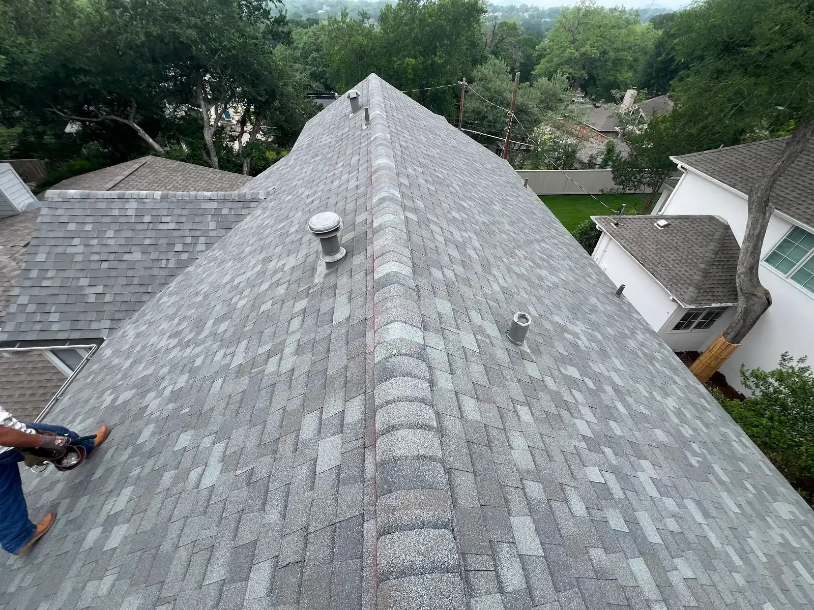 View down the main ridge of the new Landmark shingle roof with vents flashed into the field